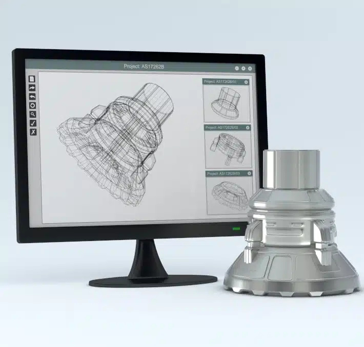 A computer monitor displays a 3D wireframe design of a mechanical part, showcasing the digital thread linking design to production, with the finished metal component placed beside the screen.